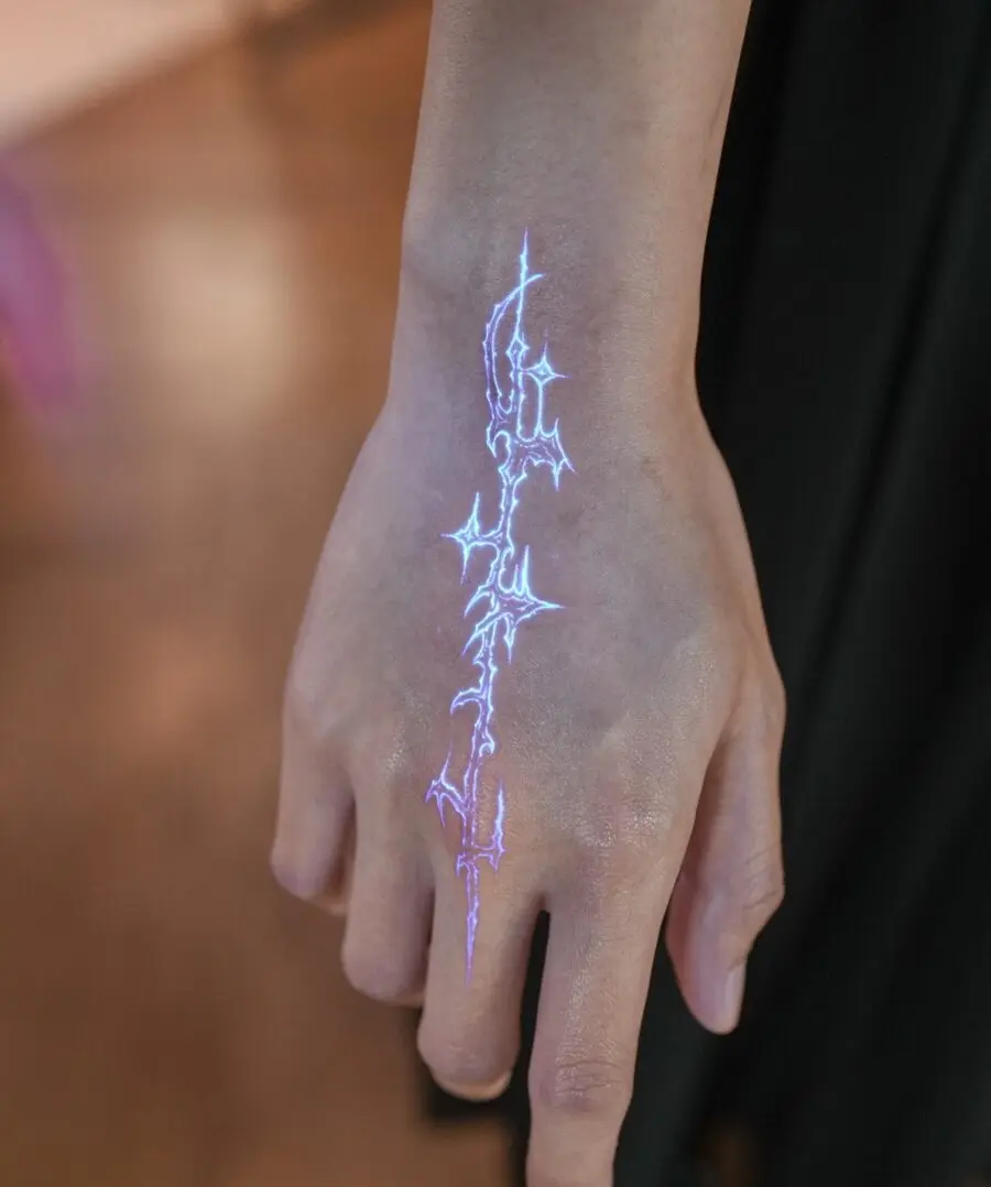 Electric blue hidden tattoo on hand