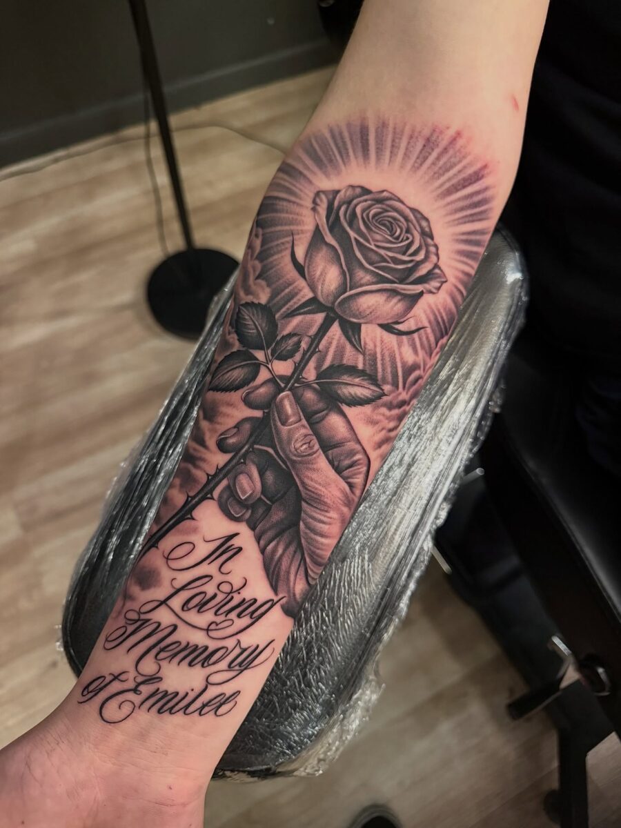 Elegant rose tattoo with heartfelt tribute lettering