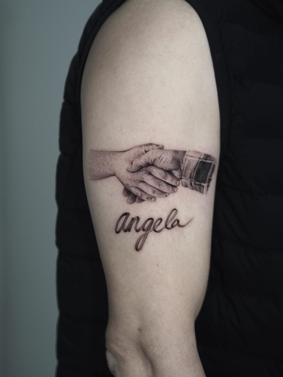 Touching tribute through hands and name tattoo