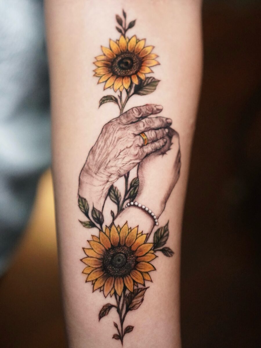 Symbolic hands and sunflowers in memory