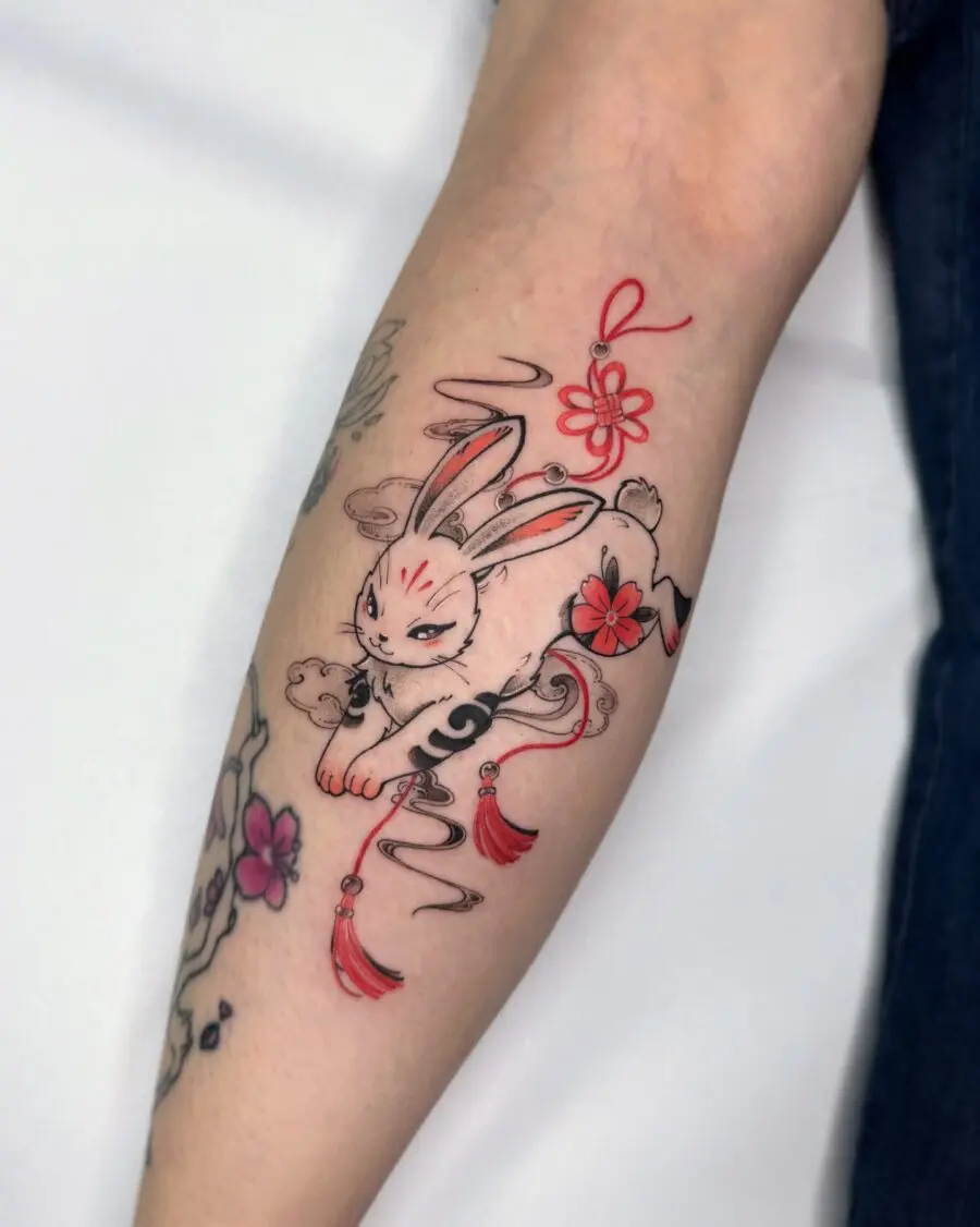 Whimsical rabbit tattoo with floral elements