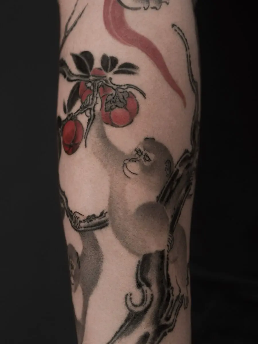 Japanese tattoo featuring playful macaques and fruit