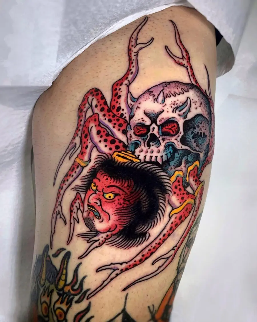Striking Japanese tattoo featuring skull and spider.