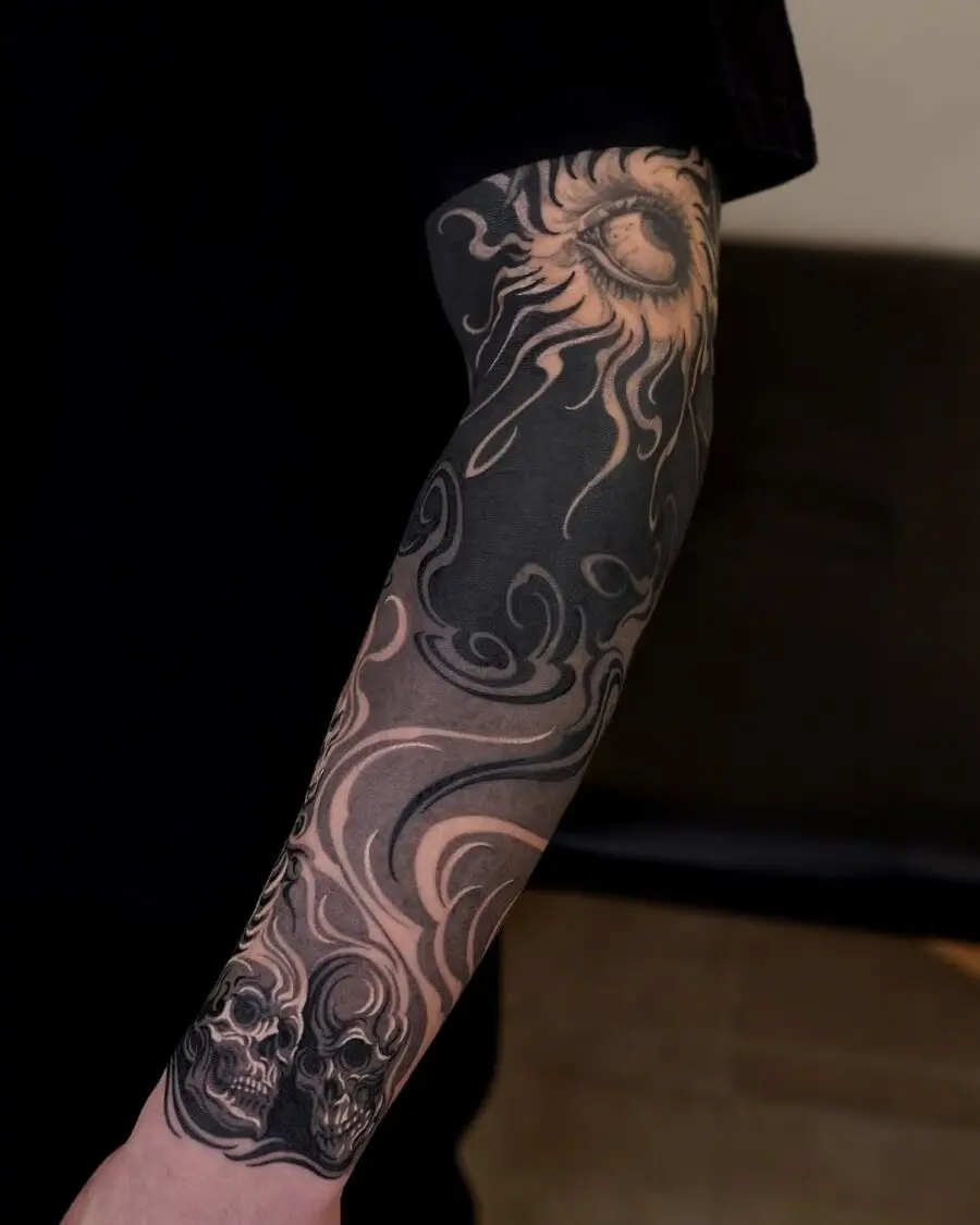 Intricate Japanese tattoo featuring sun and skulls
