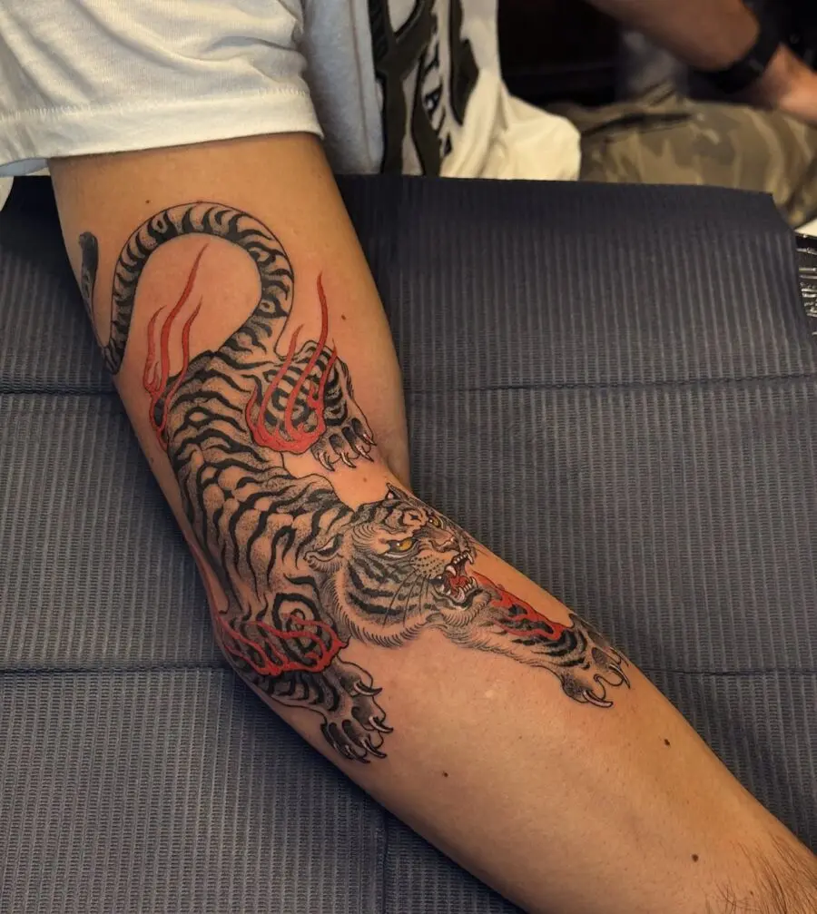 Striking tiger tattoo with bold red flames