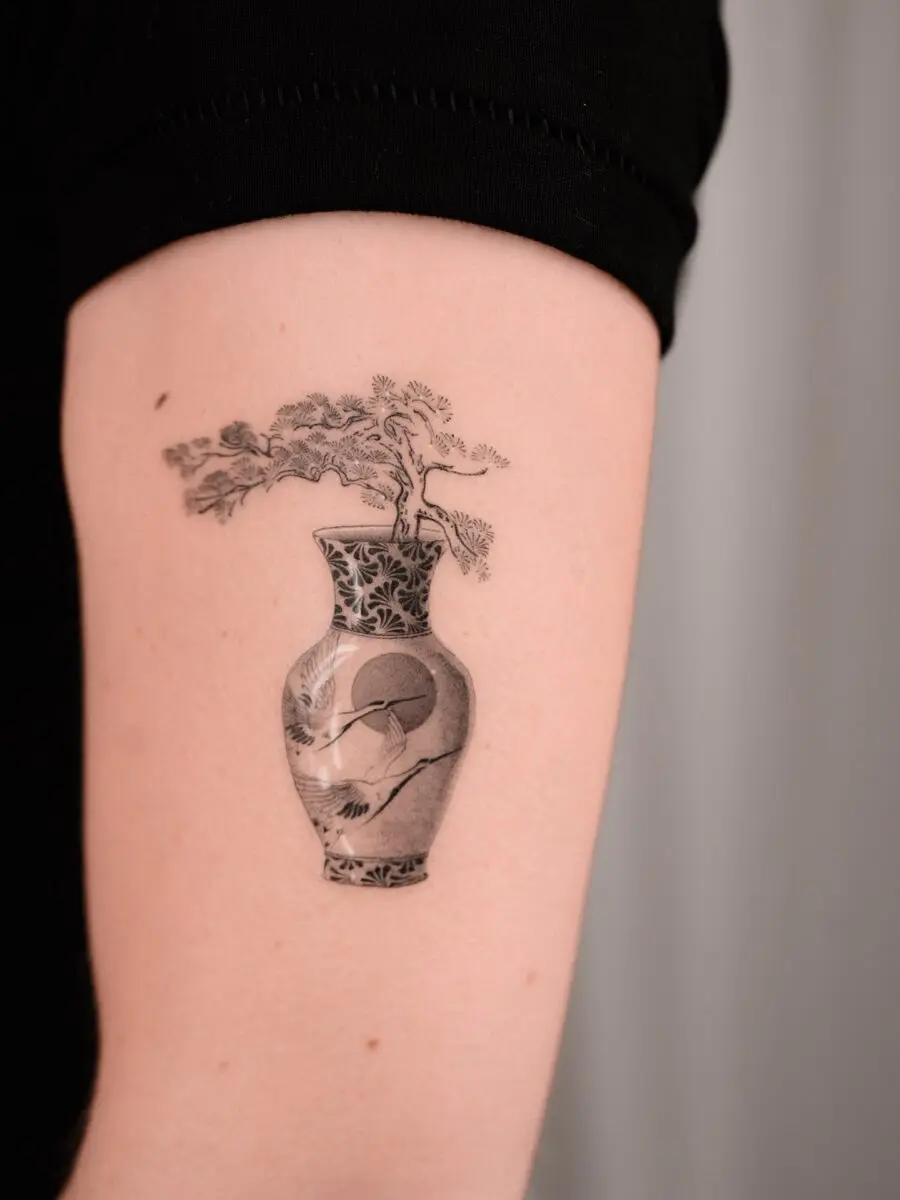 Elegant bonsai tattoo in a detailed vase