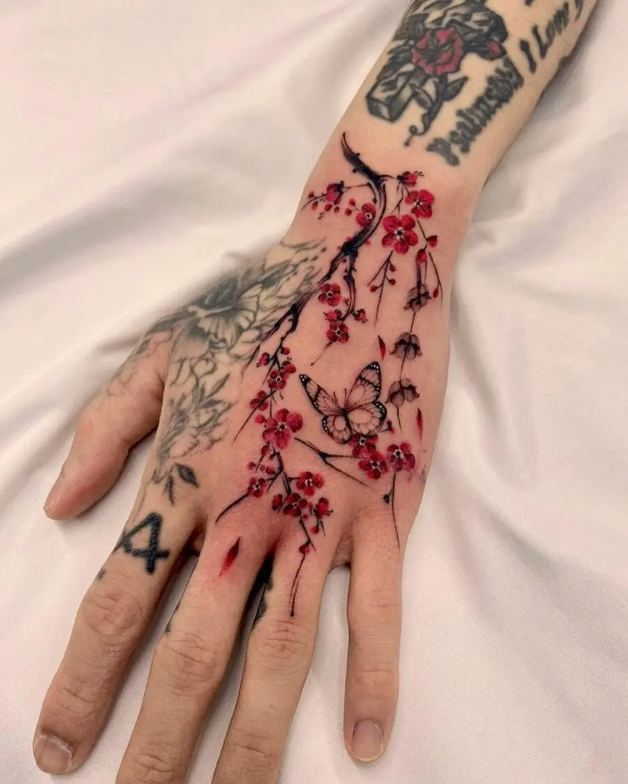 Elegant floral hand tattoo featuring a butterfly