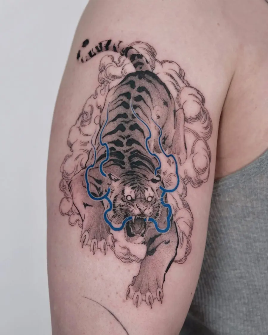 Powerful tiger tattoo surrounded by mystical clouds