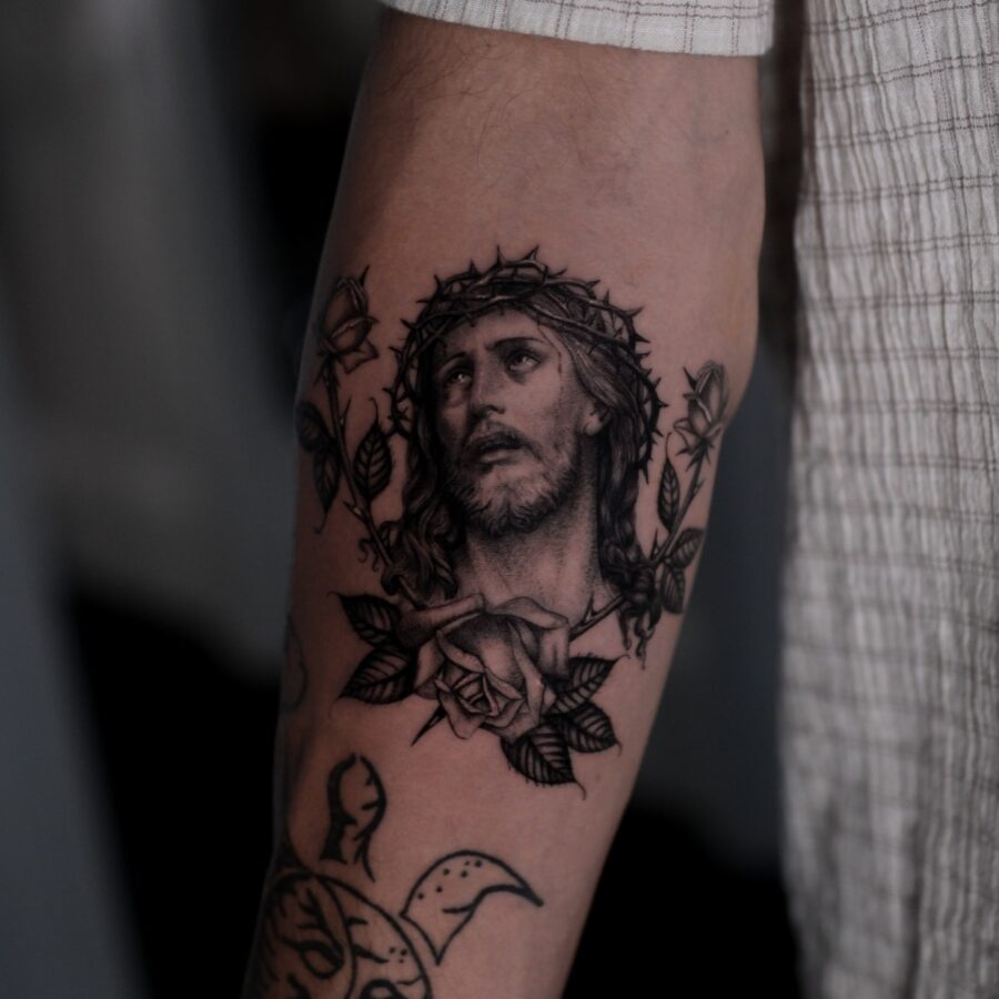Intricate Jesus tattoo with rose accents