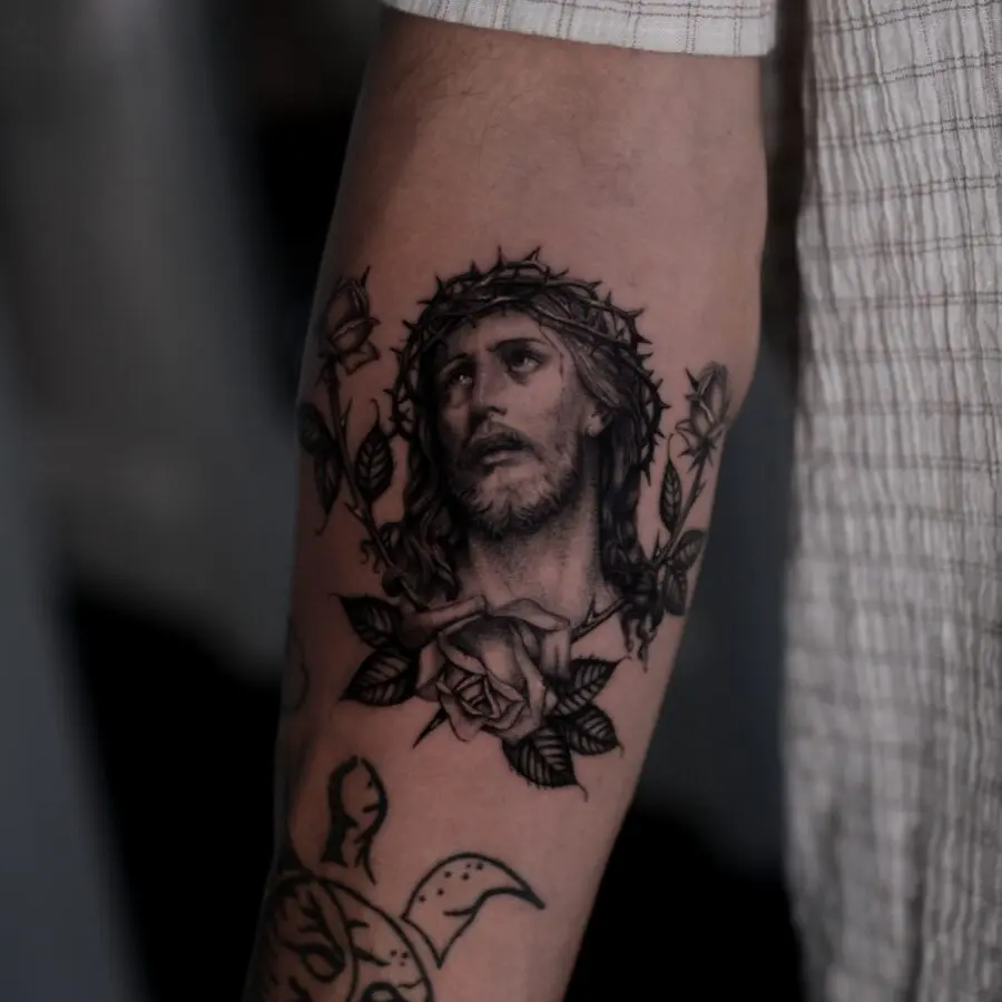 Intricate Jesus tattoo with rose accents