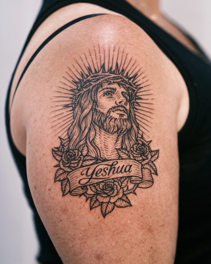Intricate Yeshua tattoo with floral accents