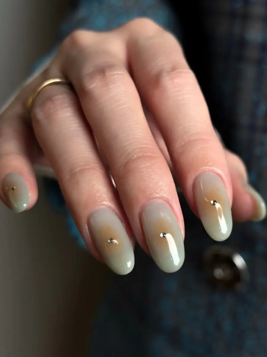 Elegant ombre nails with subtle gemstone accents