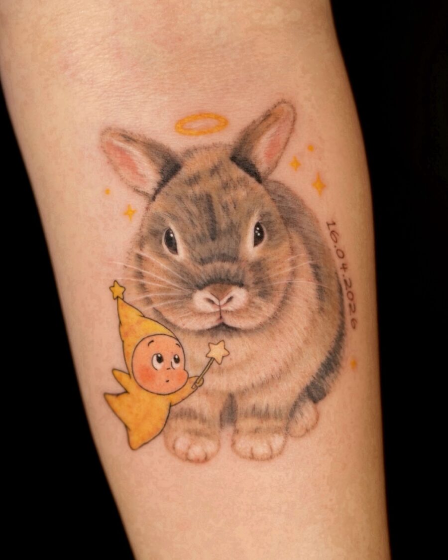 Charming rabbit memorial tattoo with angelic touch