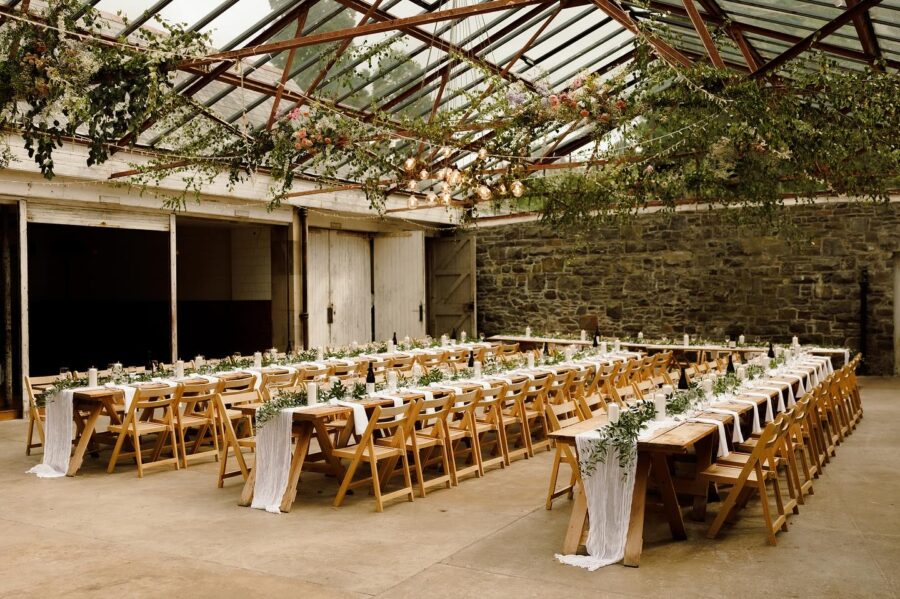Charming rustic dining setup in glasshouse venue