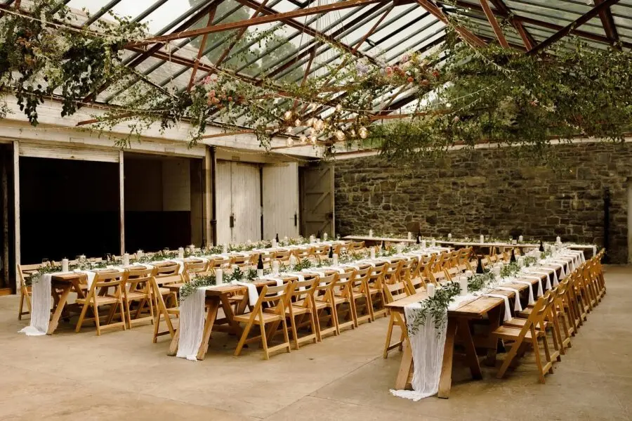 Charming rustic dining setup in glasshouse venue