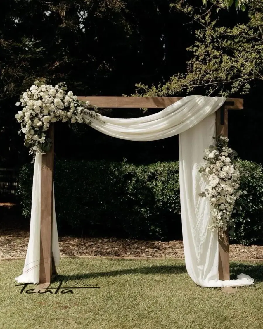 Charming rustic wedding arch adorned with florals