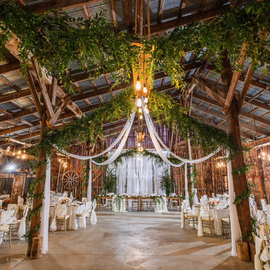 Charming rustic wedding barn decor with greenery