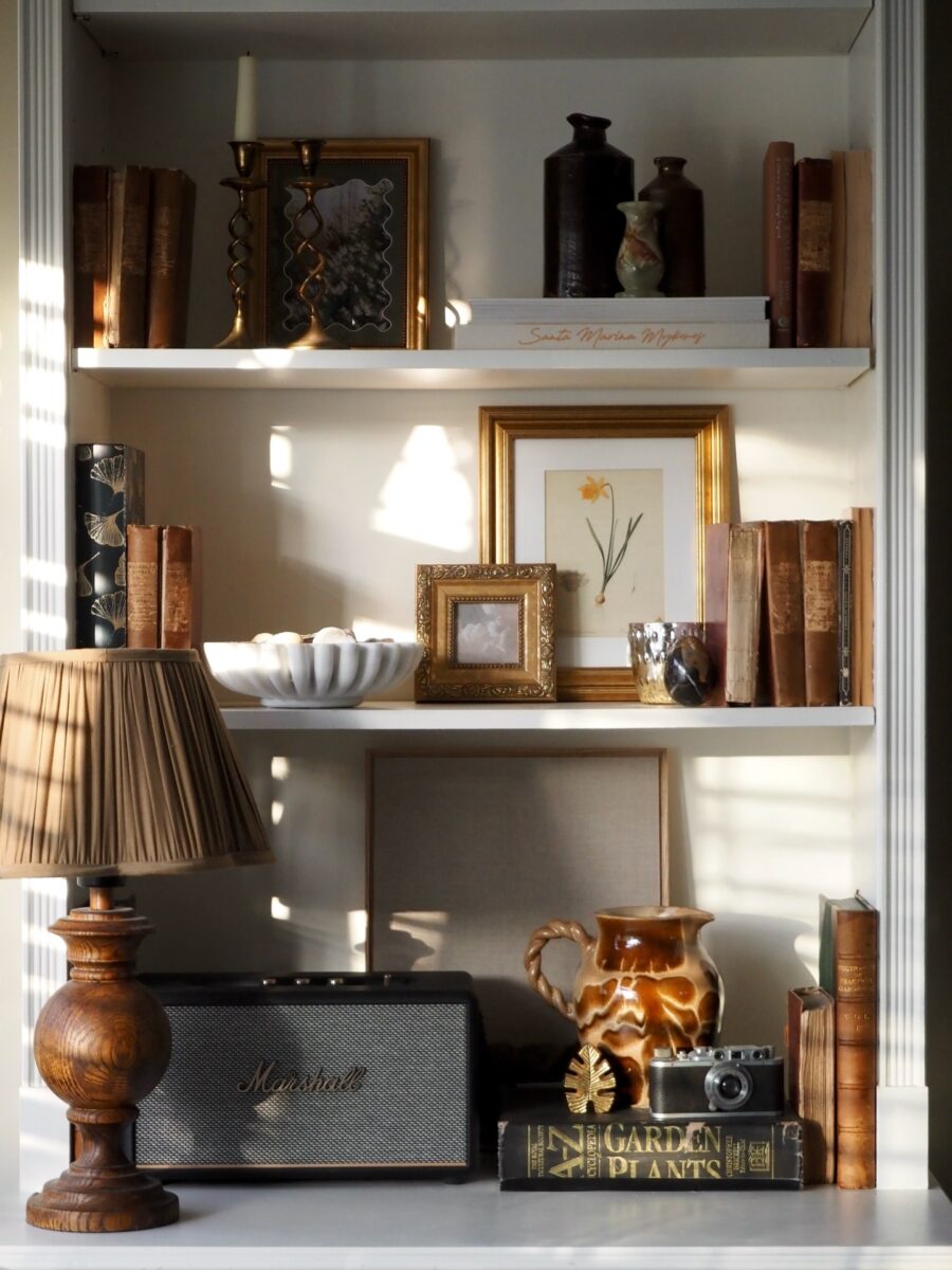 Eclectic vintage shelf decor with warm tones