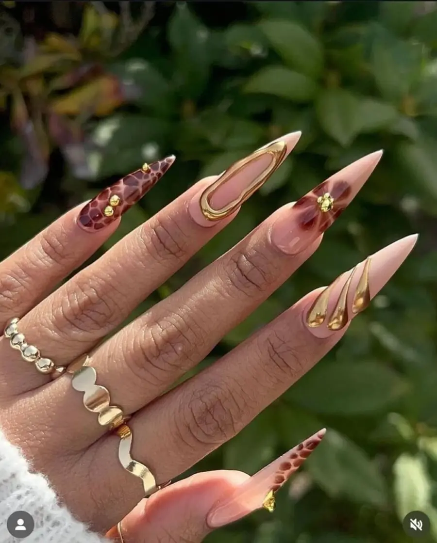 Elegant stiletto nails with gold embellishments