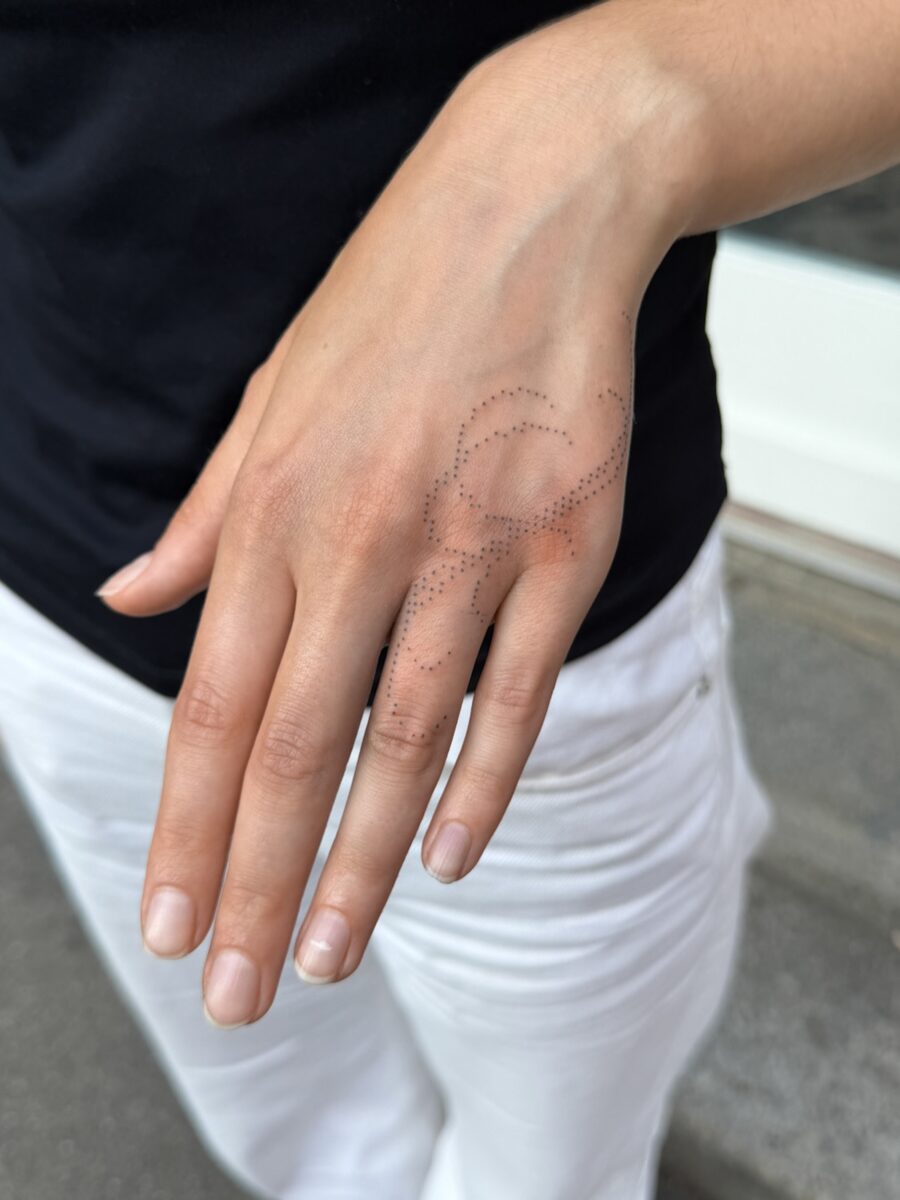 Intricate hand tattoo blending elegance and mystery