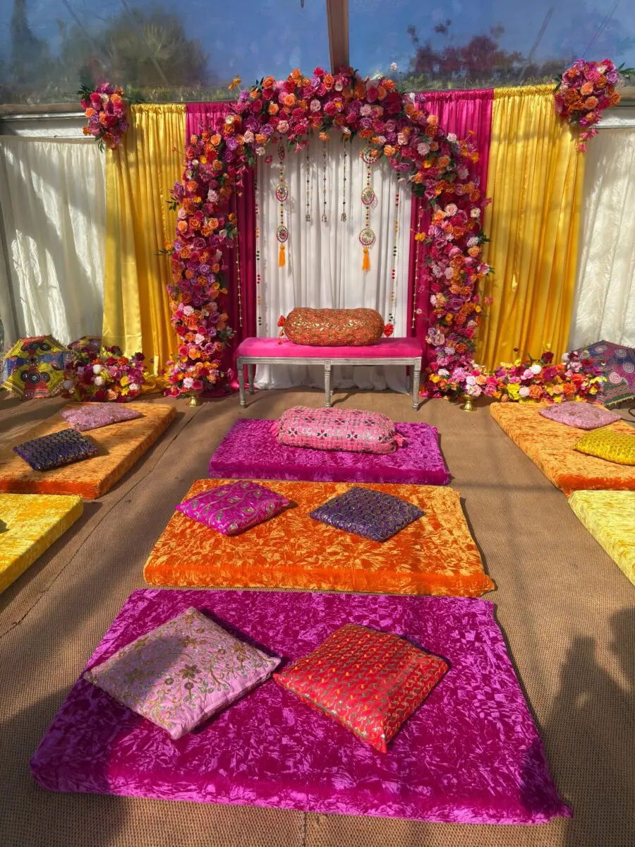 Colorful floral wedding lounge area with cushions