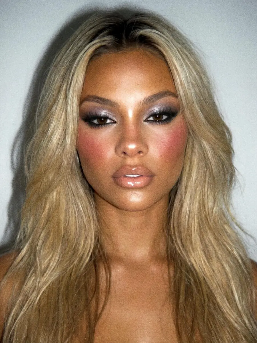 Glamorous Y2K makeup with bold shine and warmth