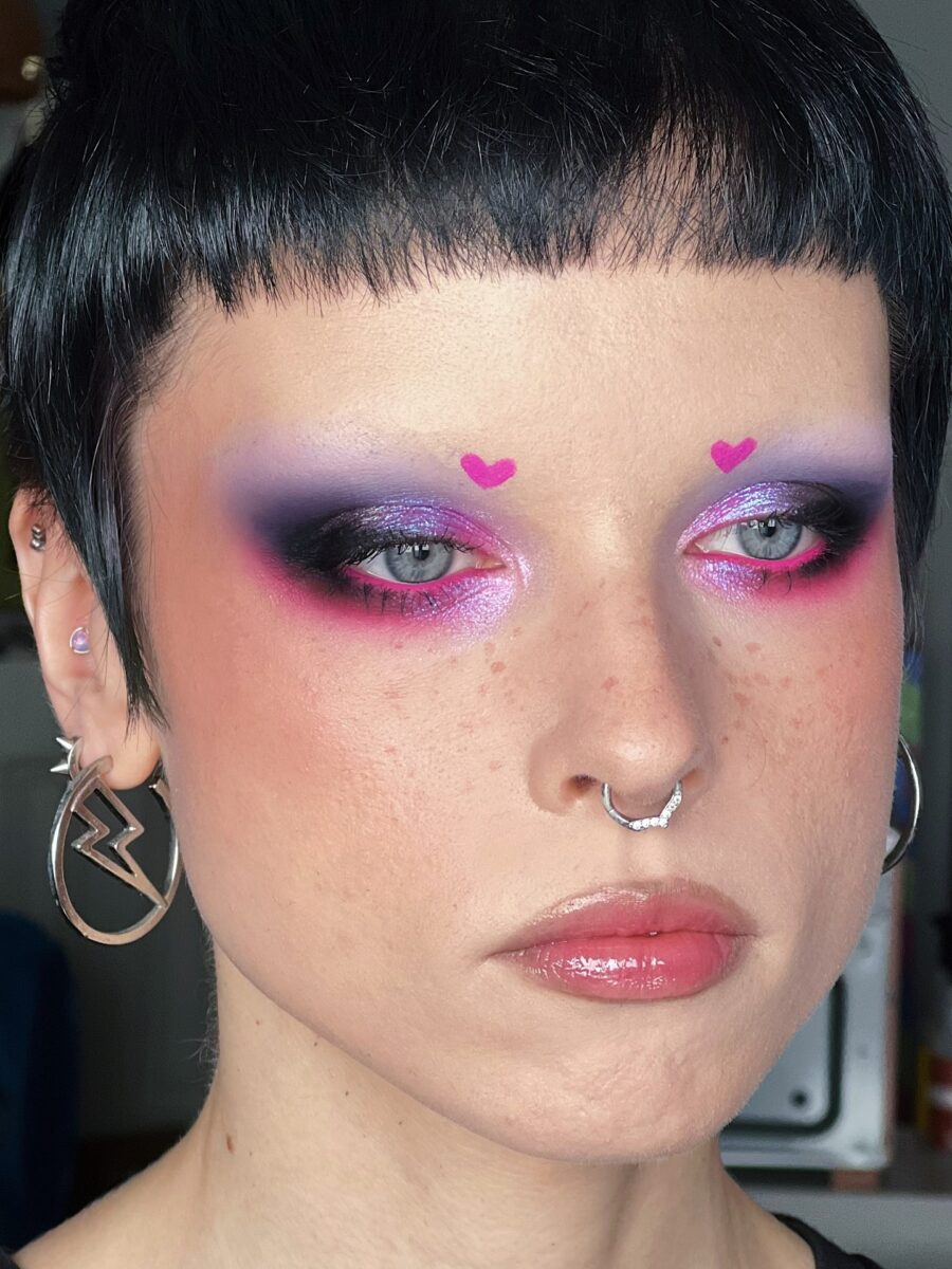 Futuristic pink heart-shaped eye makeup look