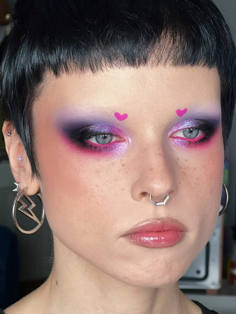 Futuristic pink heart-shaped eye makeup look
