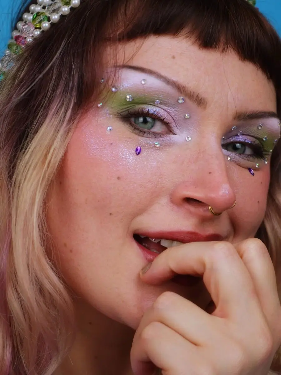 Playful Y2K makeup with vibrant rhinestone accents