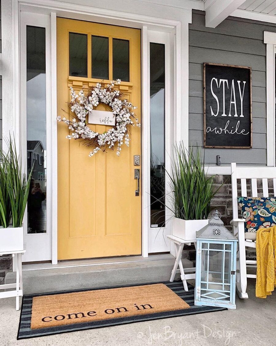 Bright yellow door with welcoming decor accents