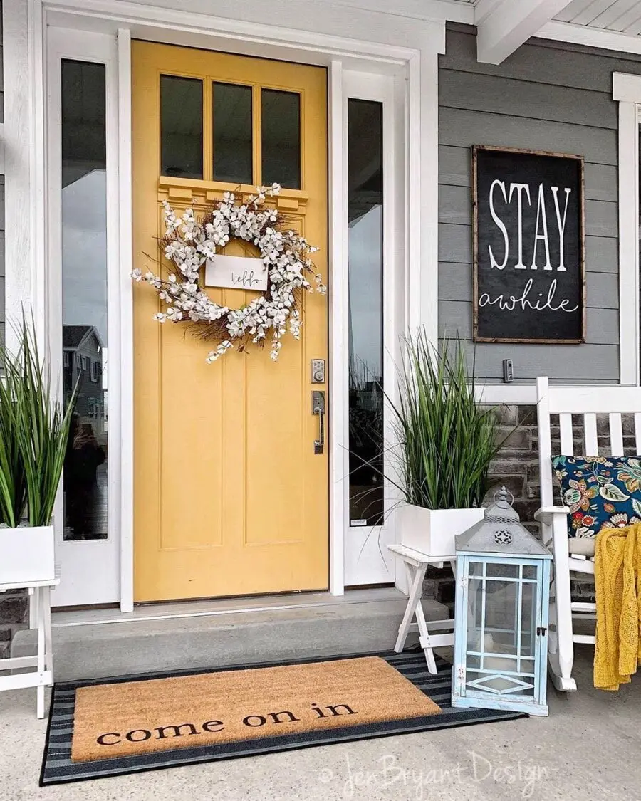 Bright yellow door with welcoming decor accents